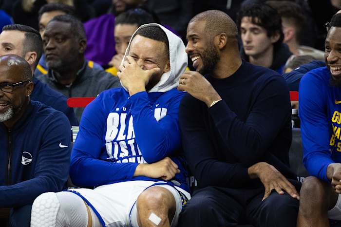 Golden State Warriors guard Stephen Curry (L) and Chris Paul (R) share a laugh during the fourth quarter against the Philadelphia 76ers at Wells Fargo Center. Mandatory Credit: Bill Streicher-USA TODAY Sports